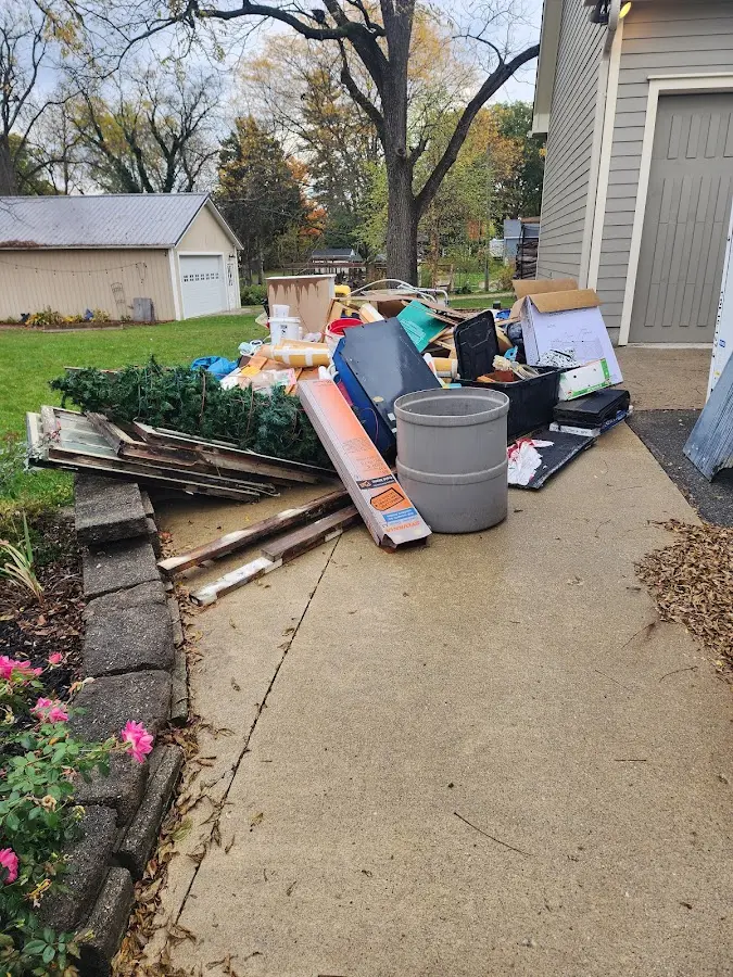 Dumpster being loaded with debris for Estate Cleanout Dumpster Rental in Runnemede